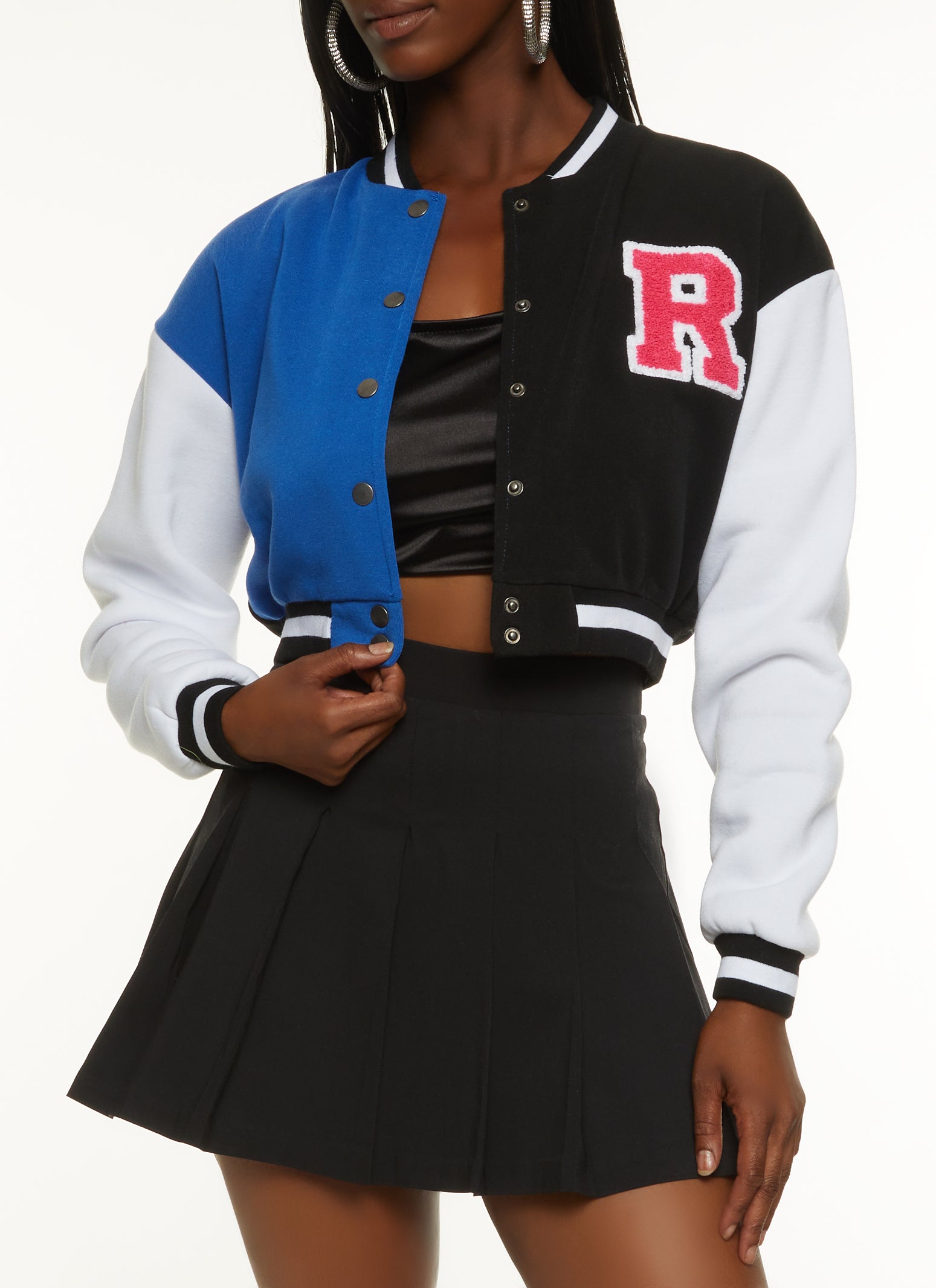 black varsity letterman jacket with white crop top and sweatpants